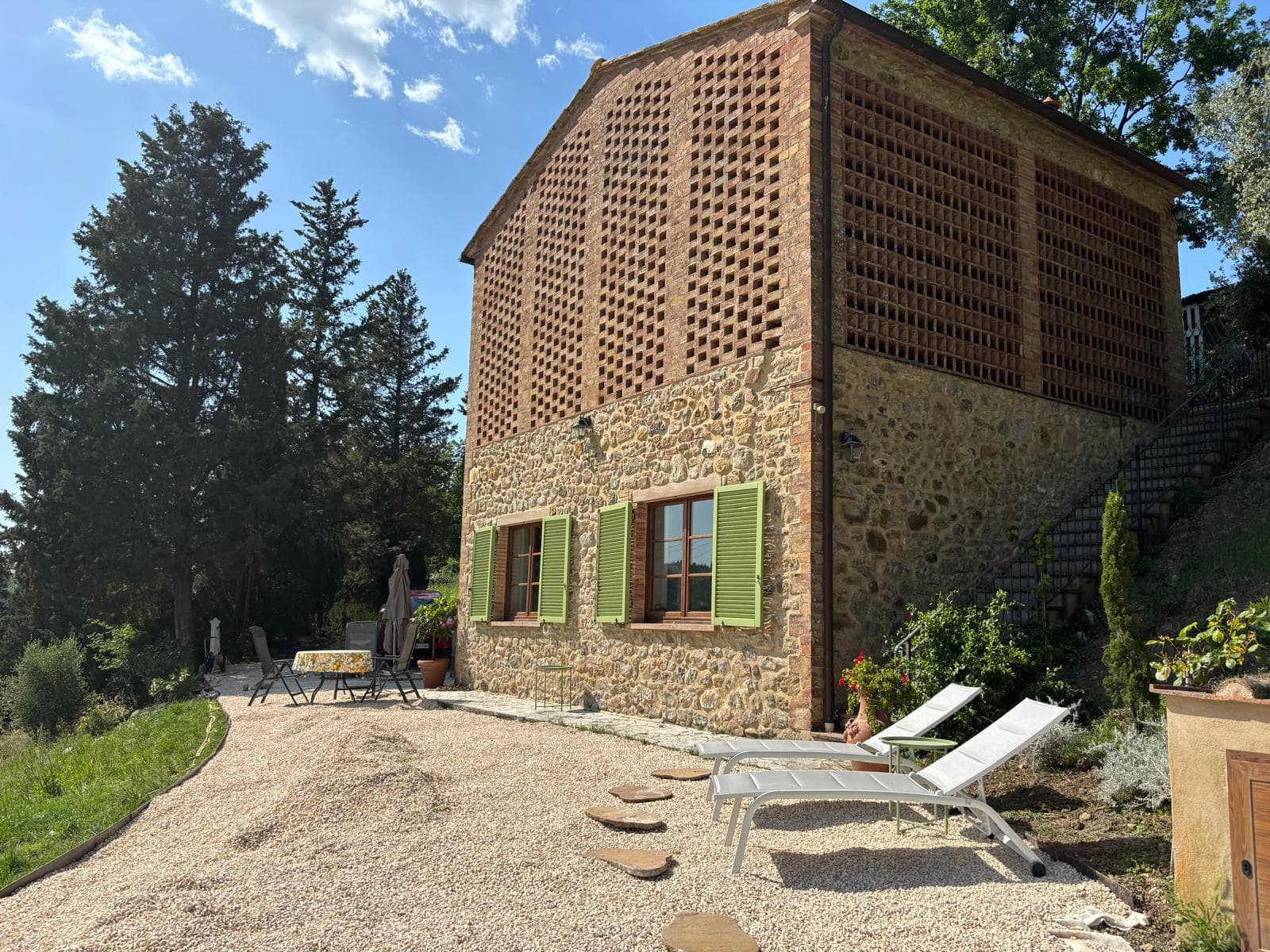 Stone villa rear facade with brick-lattice upper floor
