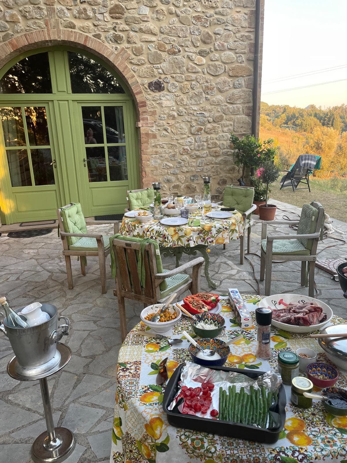 Terrace dinner spread on a lemon-print cloth at golden hour
